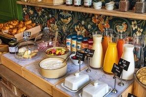 A breakfast buffet with various food items and beverages.