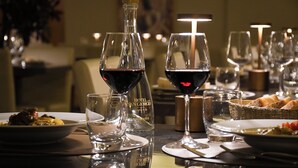 A dining table with wine glasses, a bottle, and plates of food. - Hotel San Giorgio  Heaven Spa (Fiuggi)