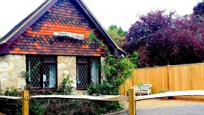 A traditional building with a tiled roof and a sign reading "Tovey Lodge." - Tovey Lodge (Hassocks)