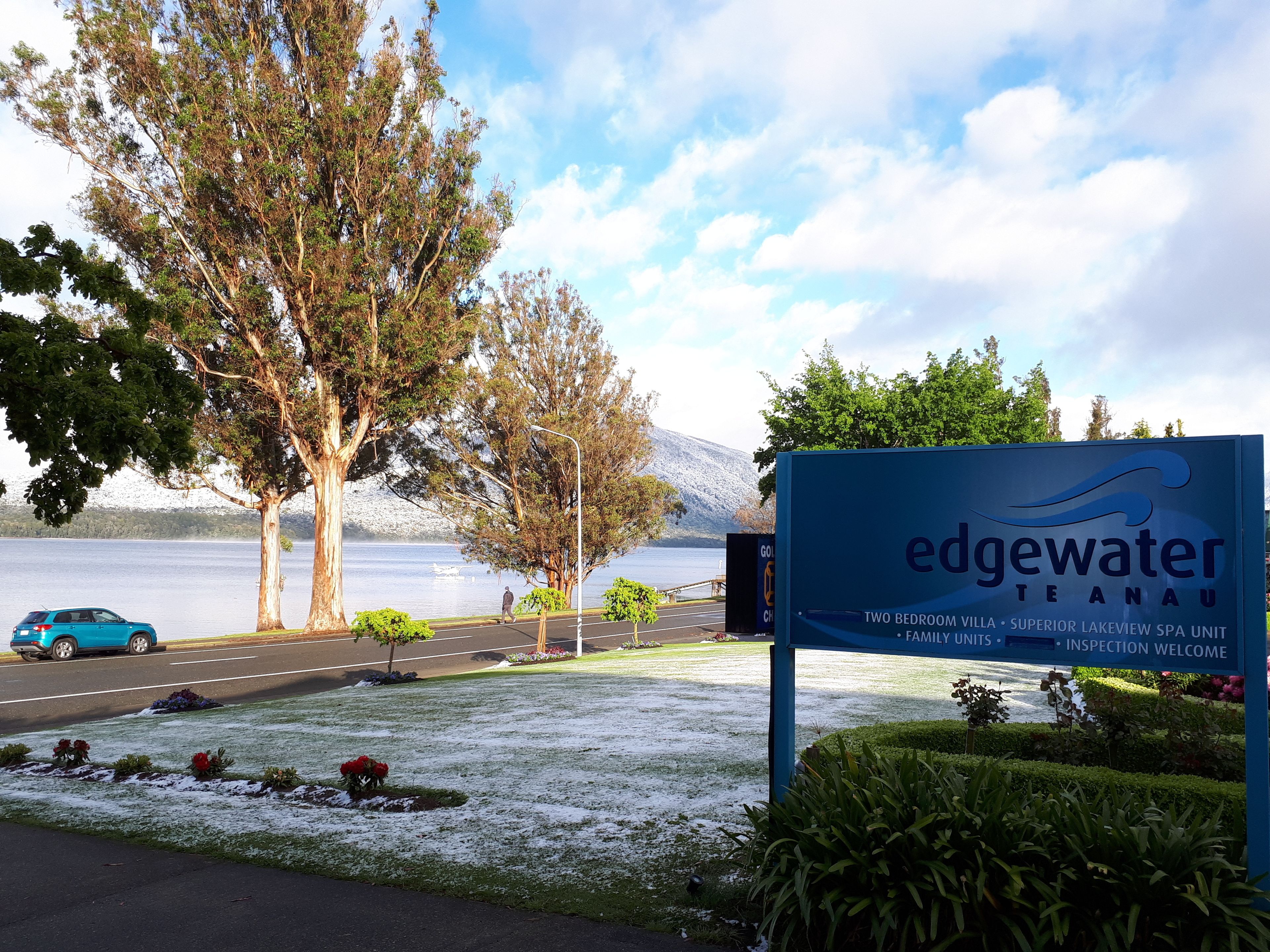A sign for Edgewater Te Anau, indicating it offers two-bedroom villas, superior lakeview spa units, and family units.
