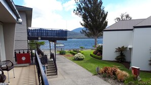 A reception area with a sign indicating 'Reception' and 'Bookings and Enquiries'. - Edgewater Motel Te Anau (Te Anau)