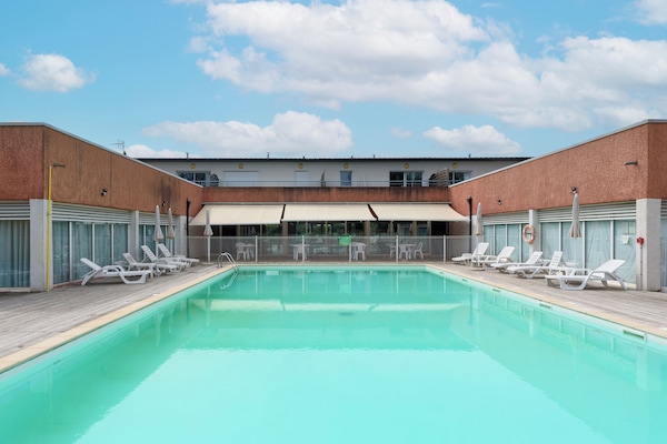 Seasonal outdoor pool, open 9:00 AM to 8:00 PM, pool umbrellas