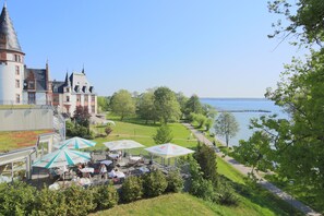Un castillo con asientos al aire libre y vistas a un lago.