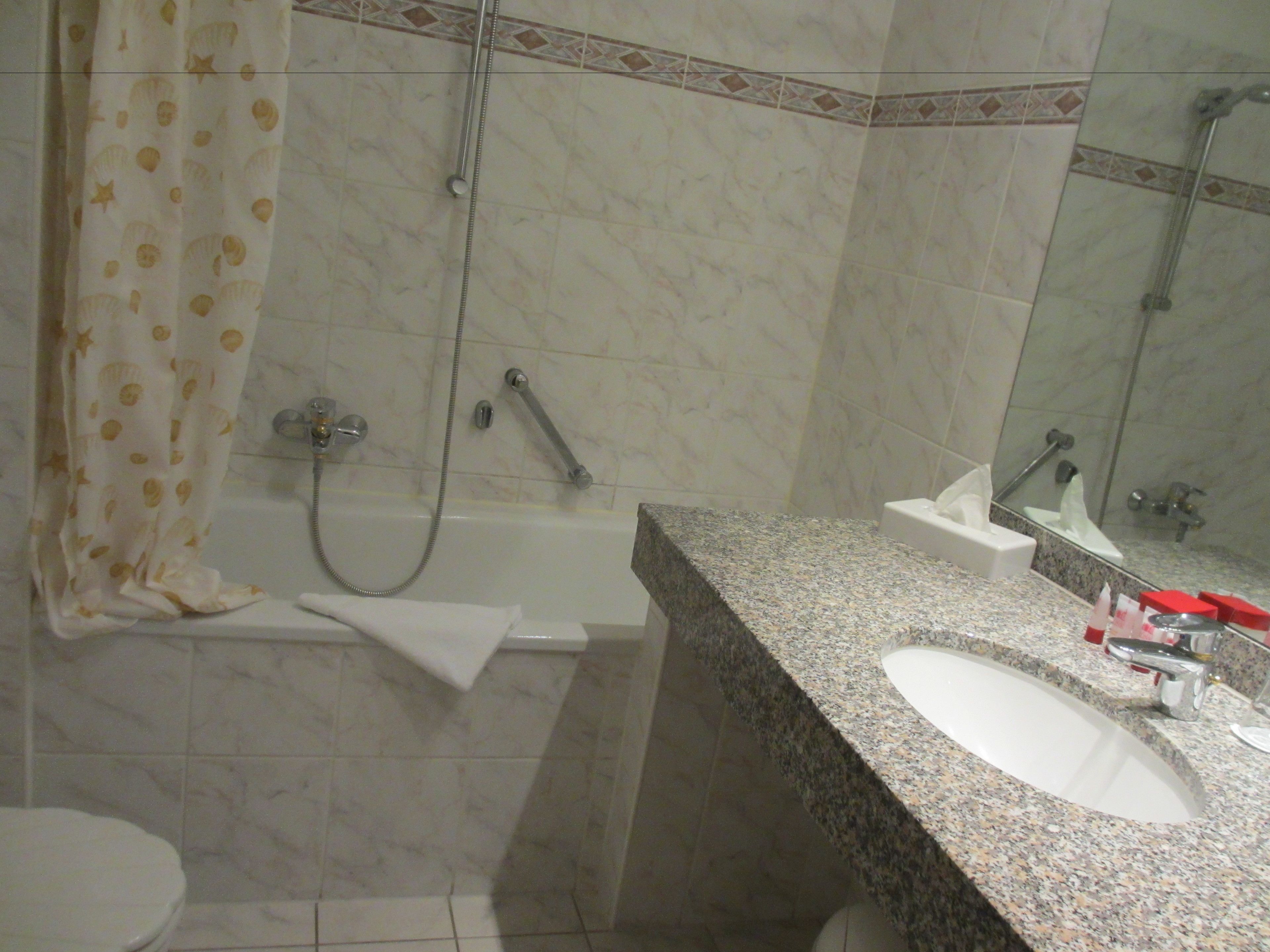 A bathroom with a bathtub, a sink, and a shower.
