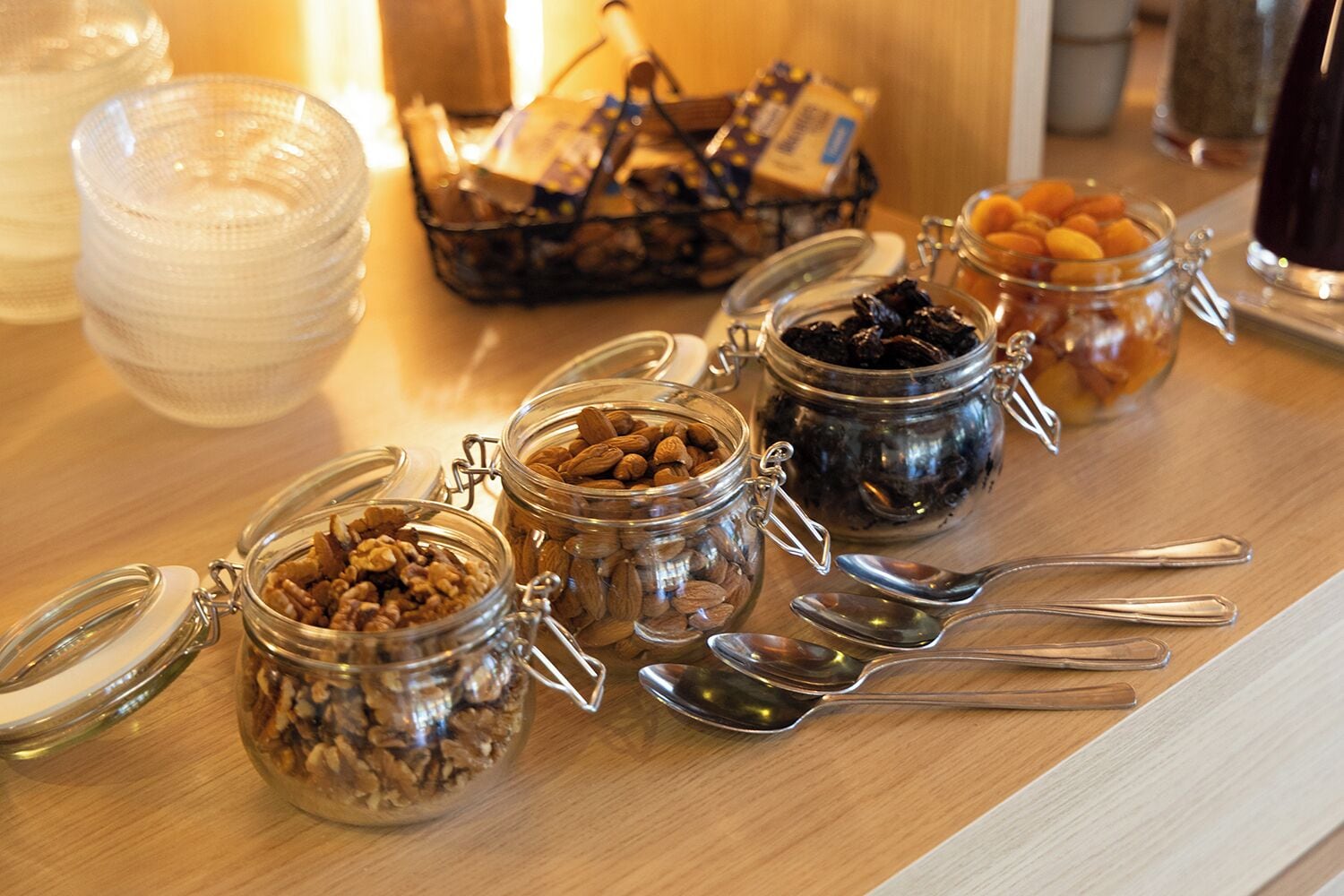 A breakfast buffet with various food items in jars and bowls.