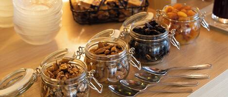 A breakfast buffet with various food items in jars and bowls.