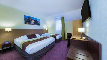 A hotel room with two beds, a desk, a chair, a TV, and a painting on the wall.