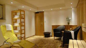 Relax in this inviting room with a wooden chair, wicker chair, and wooden table, perfect for unwinding.