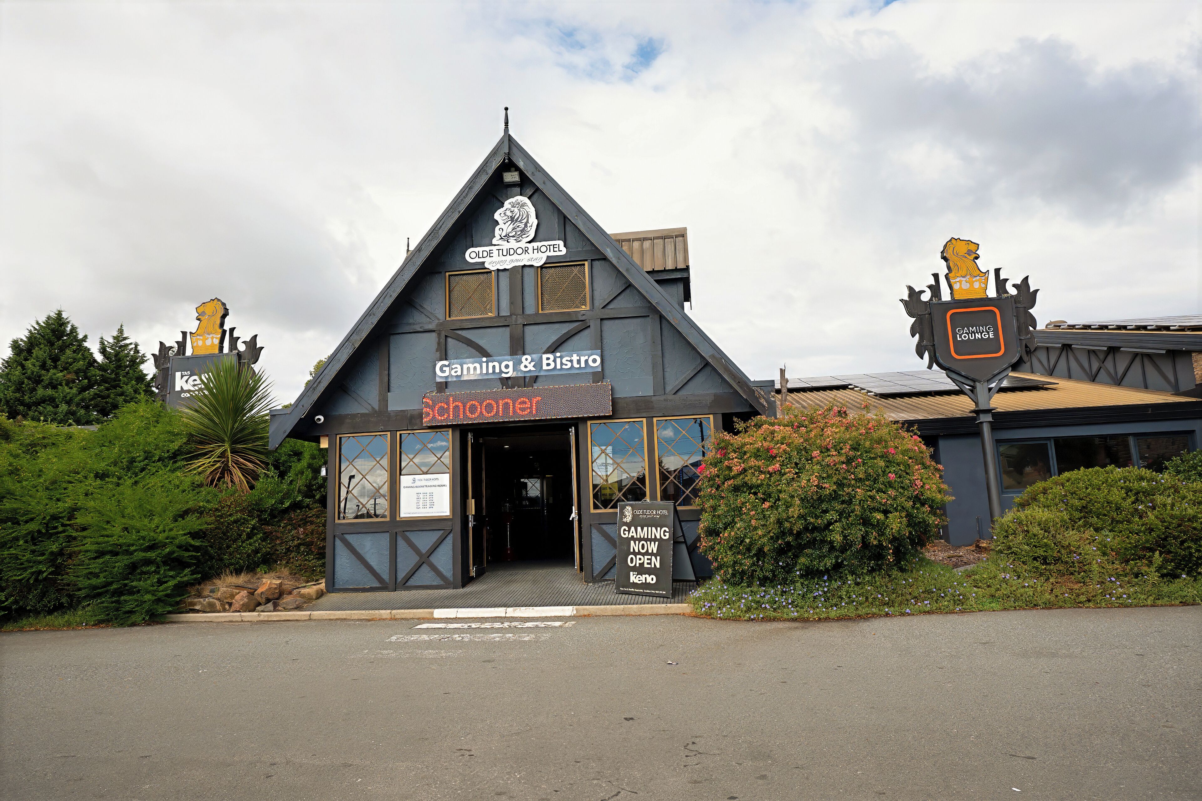 A building with a sign for 'Gaming & Bistro' and a 'Gaming Lounge' sign on the roof.