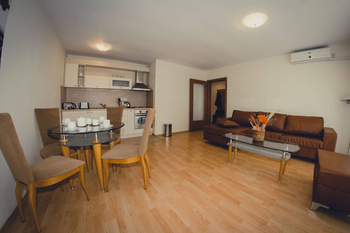 A compact living space with a dining area, a sofa, and a coffee table.