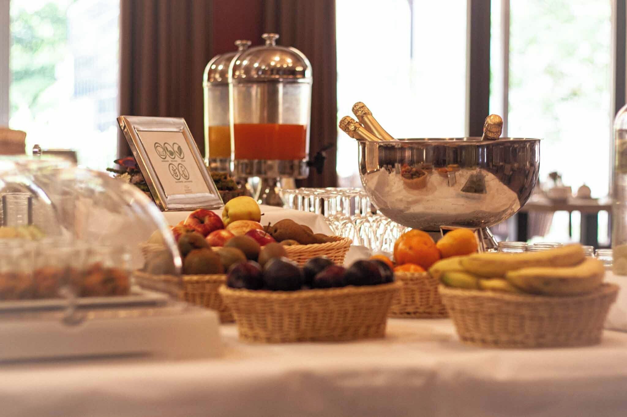 A buffet setup with various food items and a sign indicating a price of $5.00.