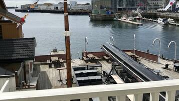 A waterfront view with a dock, boats, and buildings in the background.