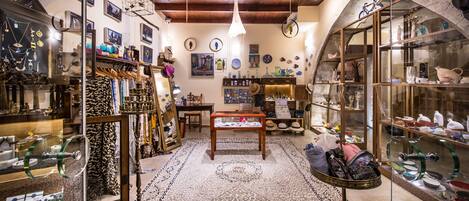 A boutique shop with a variety of jewelry and accessories displayed on shelves and tables.