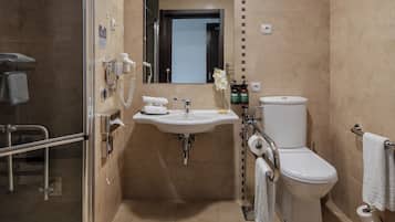 Een moderne badkamer met een douchecabine van glas, een wit wastafelmeubel met spiegel erboven en een toilet.