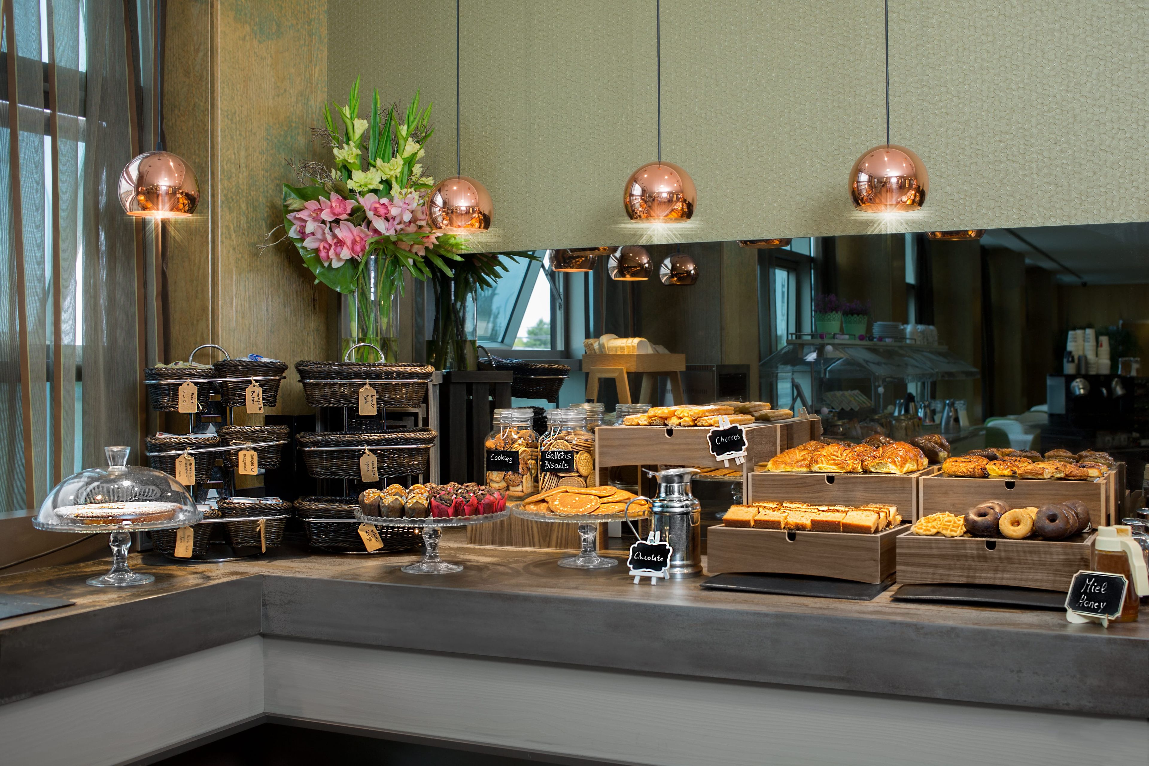 A buffet with various food items and a decorative vase.
