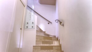 A staircase with a glass panel displaying "Locanda Alfieri" and a metal handrail. - Locanda Alfieri (Termoli)