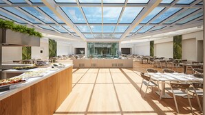 A spacious dining area with a high ceiling and skylights, featuring a central island with food displays and seating arranged around it. - VOI Marsa Siclà Essentia (Scicli)