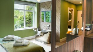 A modern bathroom with a freestanding bathtub, large windows, and a wooden vanity. - Draycote Hotel and Whitefields Golf Club (Rugby)