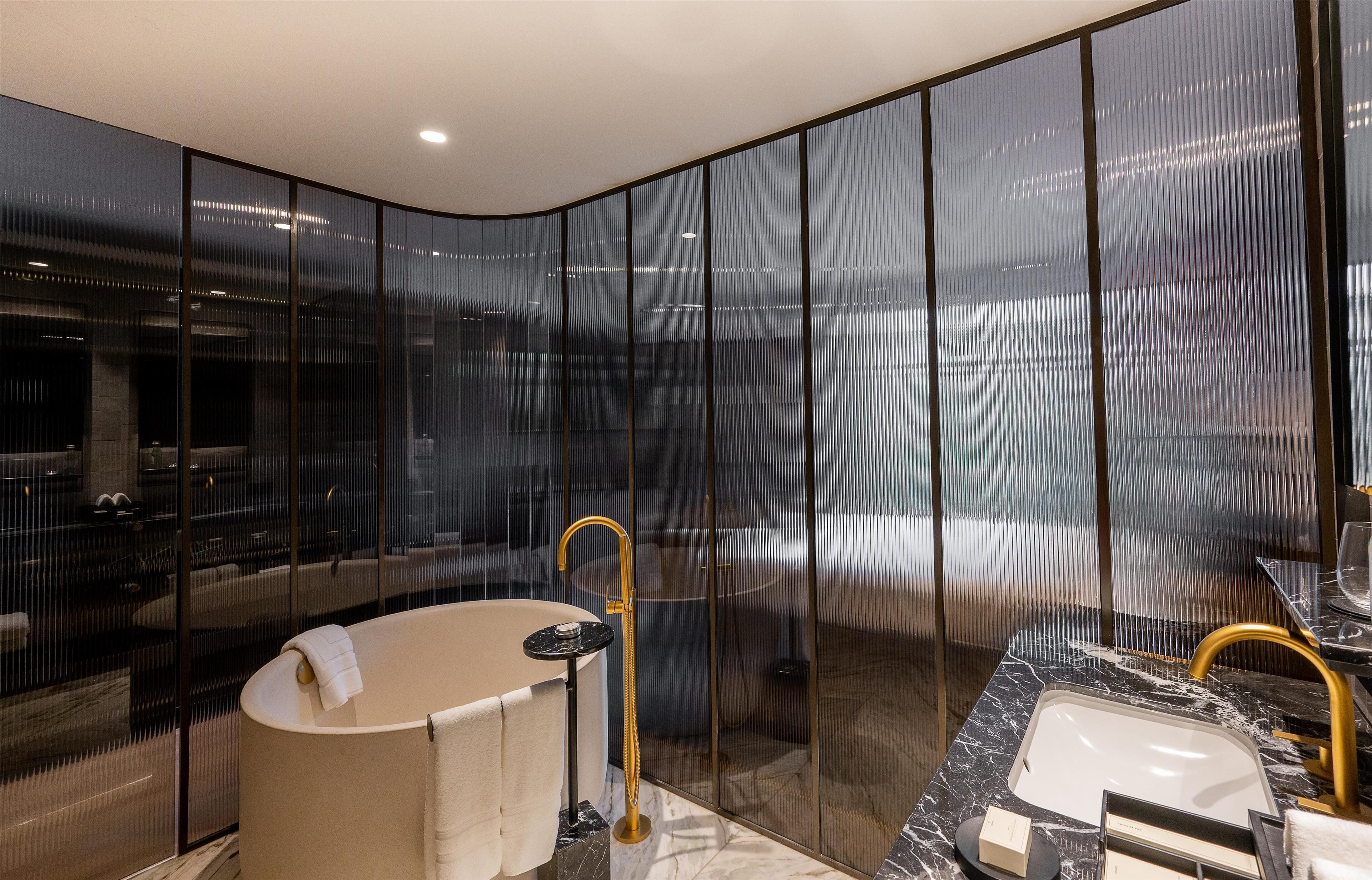 separate bathtub and shower, deep-soaking bathtub, designer toiletries