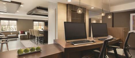 A modern office space with two desks, chairs, and a large window.