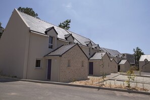 Houses with pitched roofs and small front porches line the street.