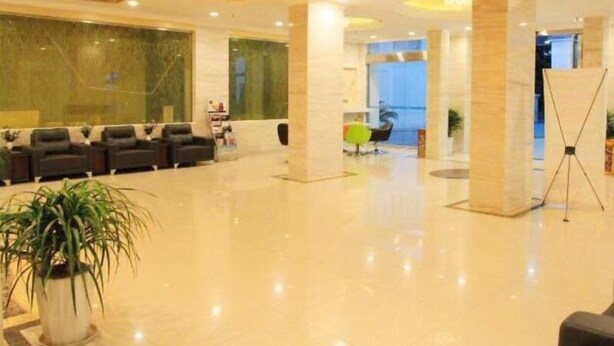 A spacious lobby with a reception desk, seating area, and a large chandelier. - GreenTree Inn Wuxi ChongAn Temple Jiefang West Road Hotel (Wuxi)