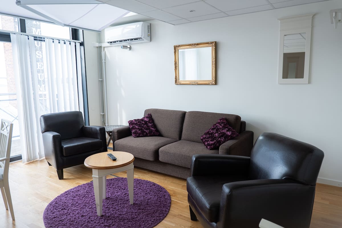 suite, hot tub, lake view | living area | flat-screen tv