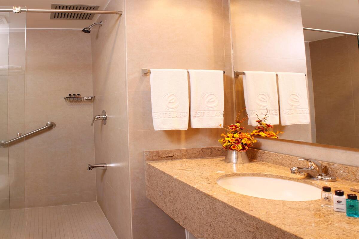Bathroom | Shower, rainfall showerhead, hair dryer, towels