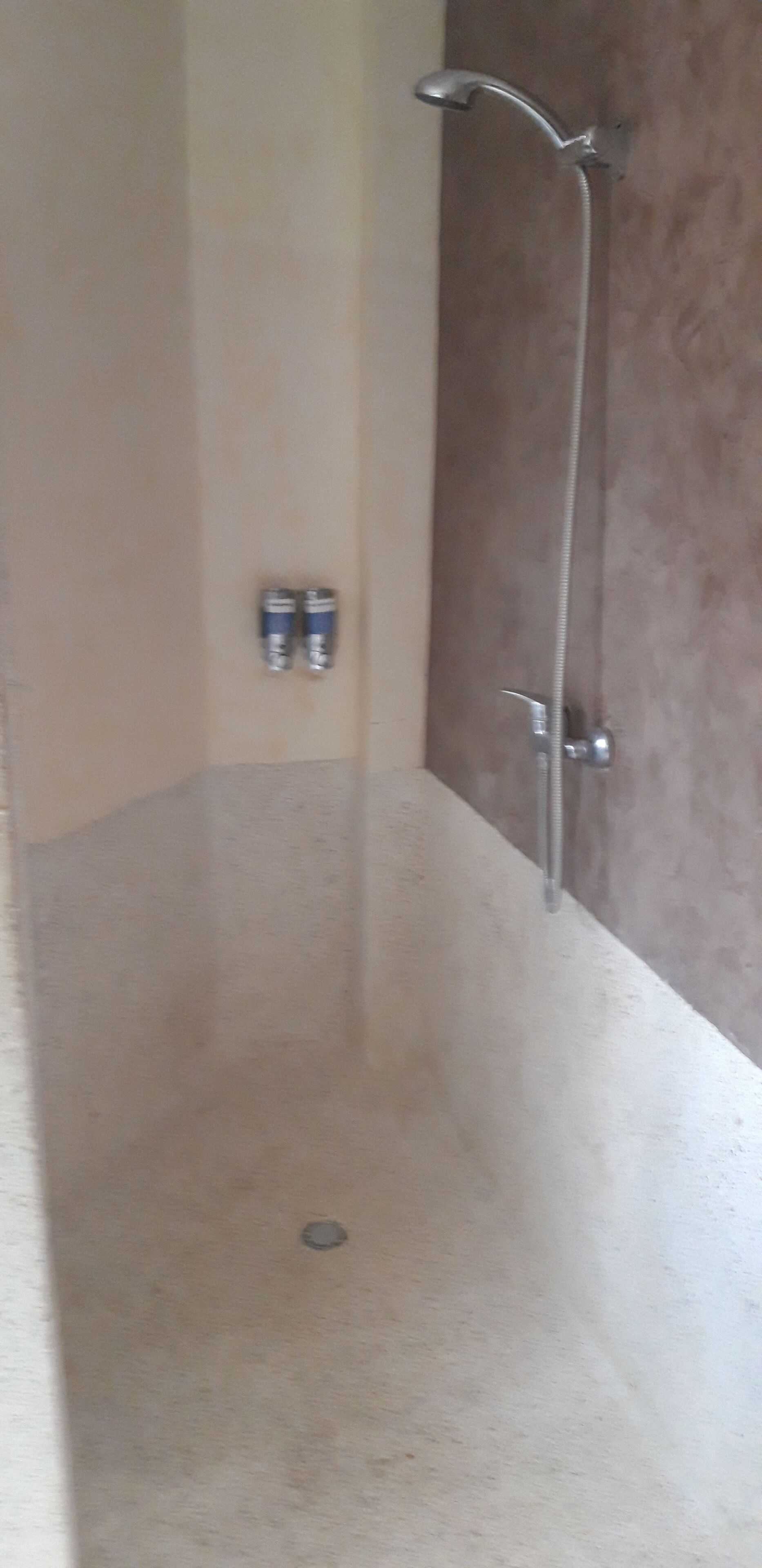 A bathroom with a shower, a toilet, and a sink.