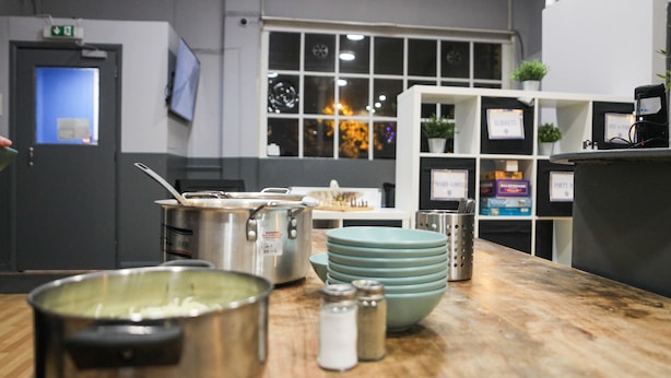A kitchen area with stainless steel pots, bowls, and salt shakers on a wooden countertop. - Onefam Waterloo 18-36 years old (London)