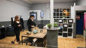 A modern interior with a wooden table, chairs, and a counter with a plant. - Onefam Waterloo 18-36 years old (London)