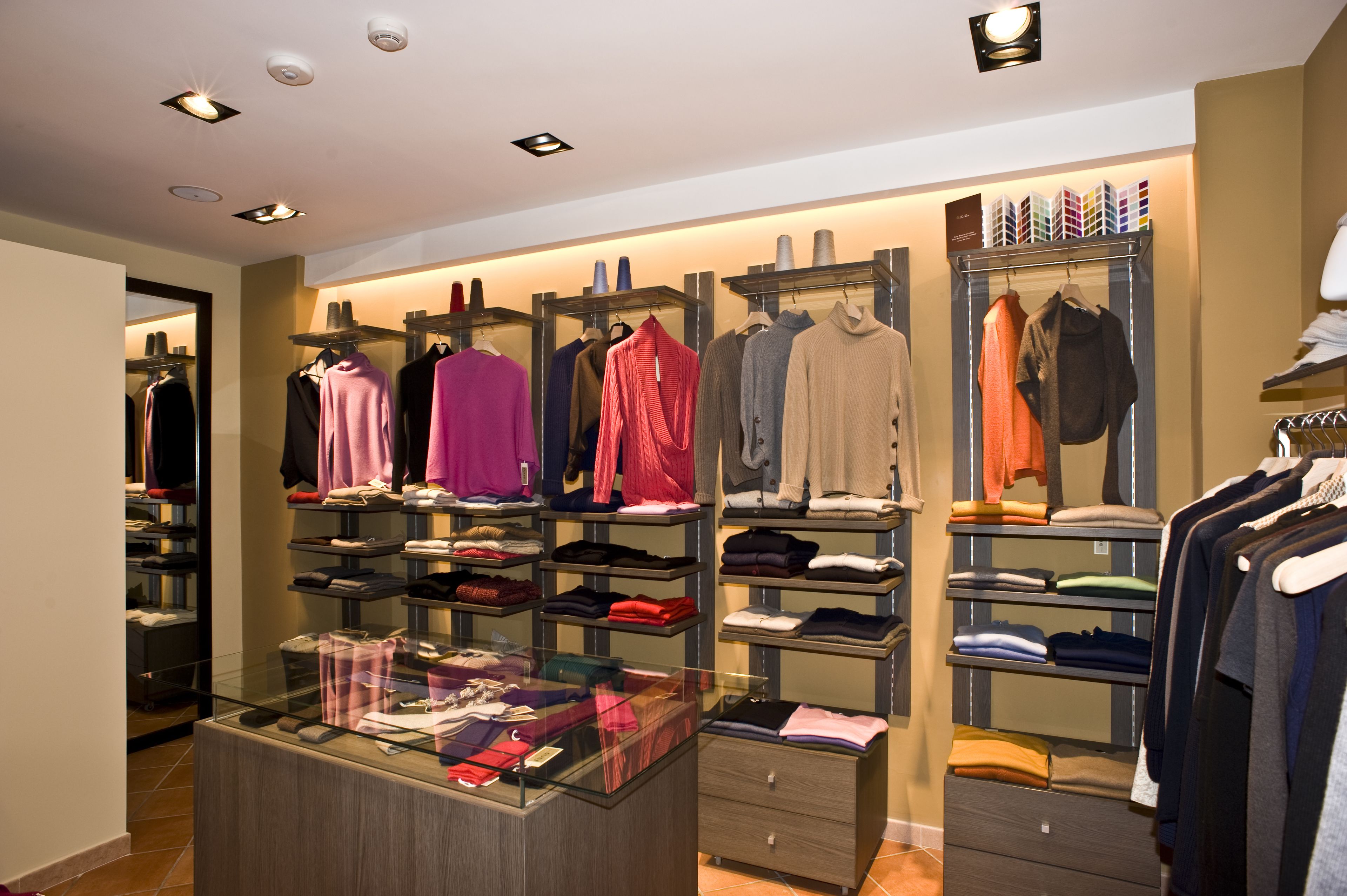 A clothing store with neatly organized shelves and racks of various garments.