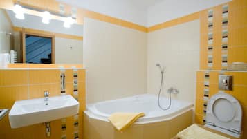 A bathroom with a sink, bathtub, and toilet.