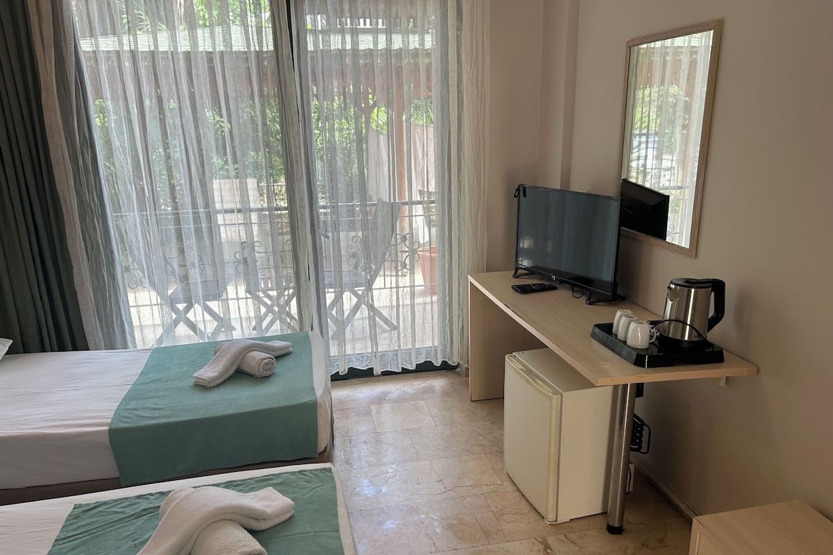 Standard Triple Room | Minibar, in-room safe, iron/ironing board, free WiFi
