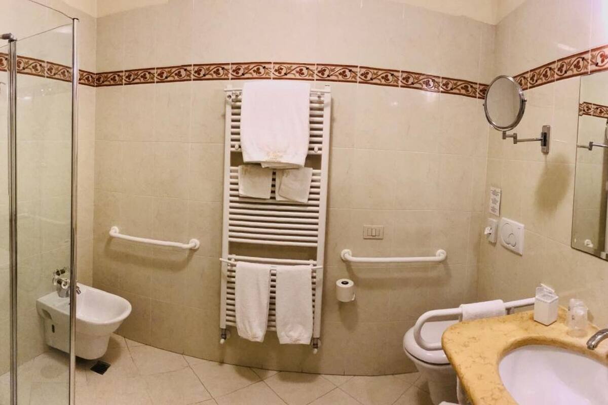 hair dryer, slippers, bidet, towels