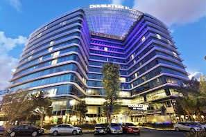 A multi-story hotel with a curved facade, large windows, and a prominent signage. - Doubletree by Hilton Istanbul Moda (Istanbul)