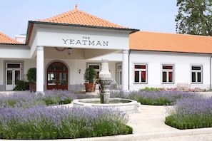 A building with a sign reading "THE YEATMAN" and a fountain in the center.