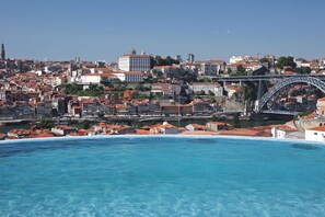 A coastal cityscape with a prominent bridge, historic buildings, and a waterfront. - The Yeatman Hotel (Vila Nova de Gaia)