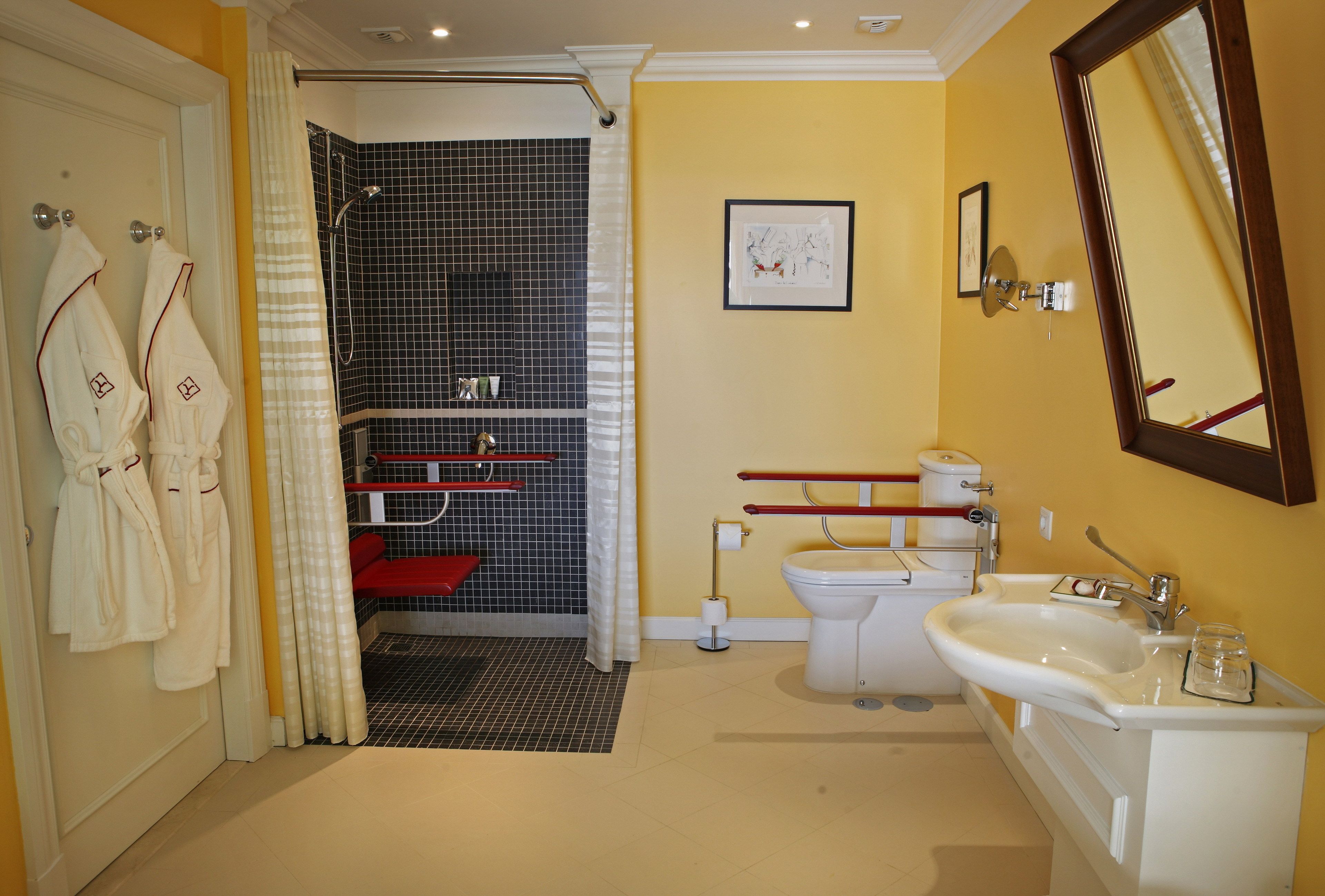 A bathroom with a shower, toilet, sink, and towels.