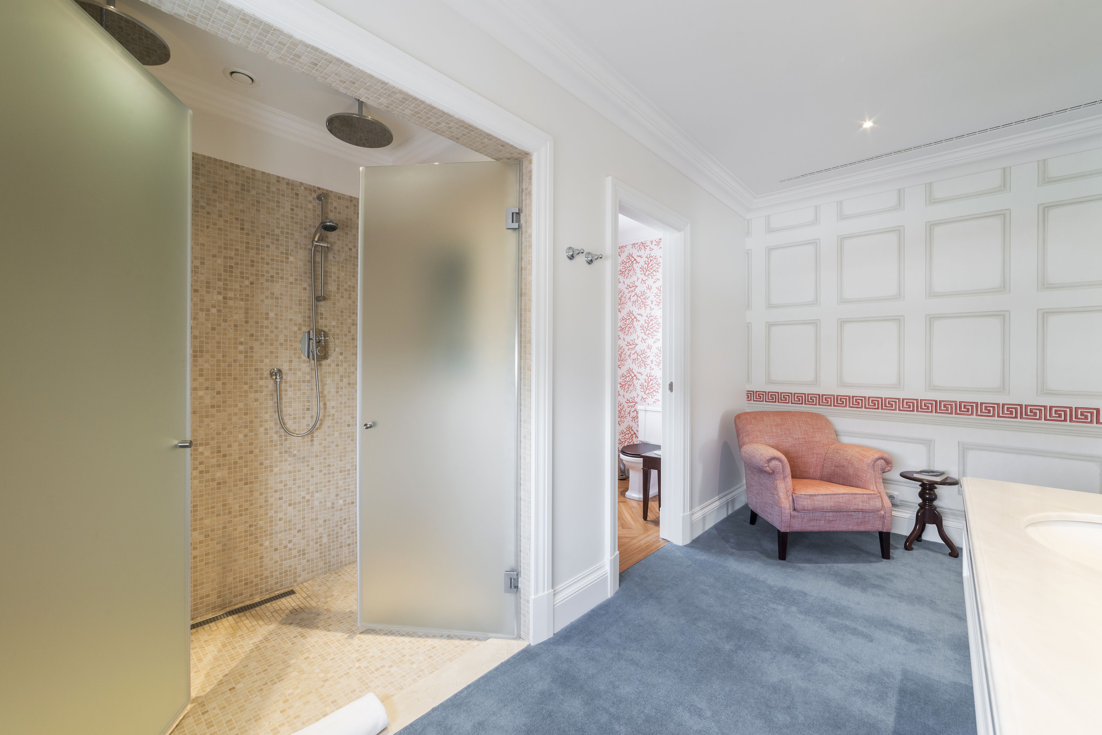 A bathroom with a shower, a toilet, and a sink.