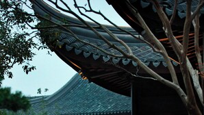 A traditional building with a tiled roof and wooden lattice windows.
