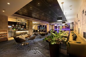 A modern bar area with seating, a wine rack, and a decorative ceiling. - Doubletree By Hilton Istanbul Old Town (Istanbul)
