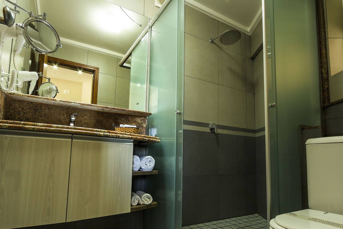 shower, designer toiletries, hair dryer, towels