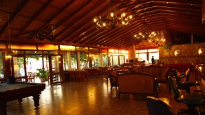 A spacious indoor area with a pool table, multiple seating arrangements, and a bar area. - Gokcen Hotel & Apartments (Fethiye)