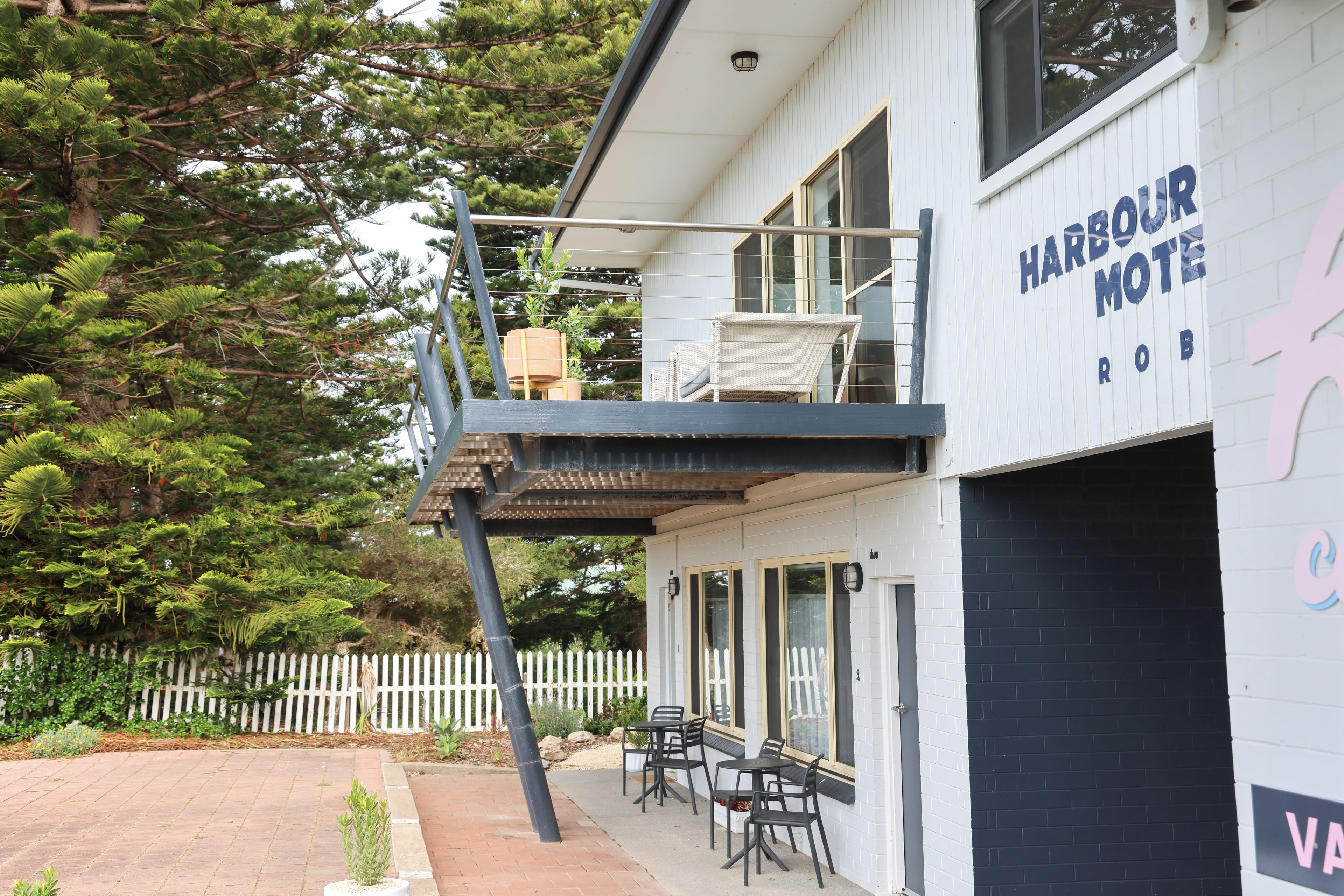 A two-story building with a sign reading 'Harbour Motel'.
