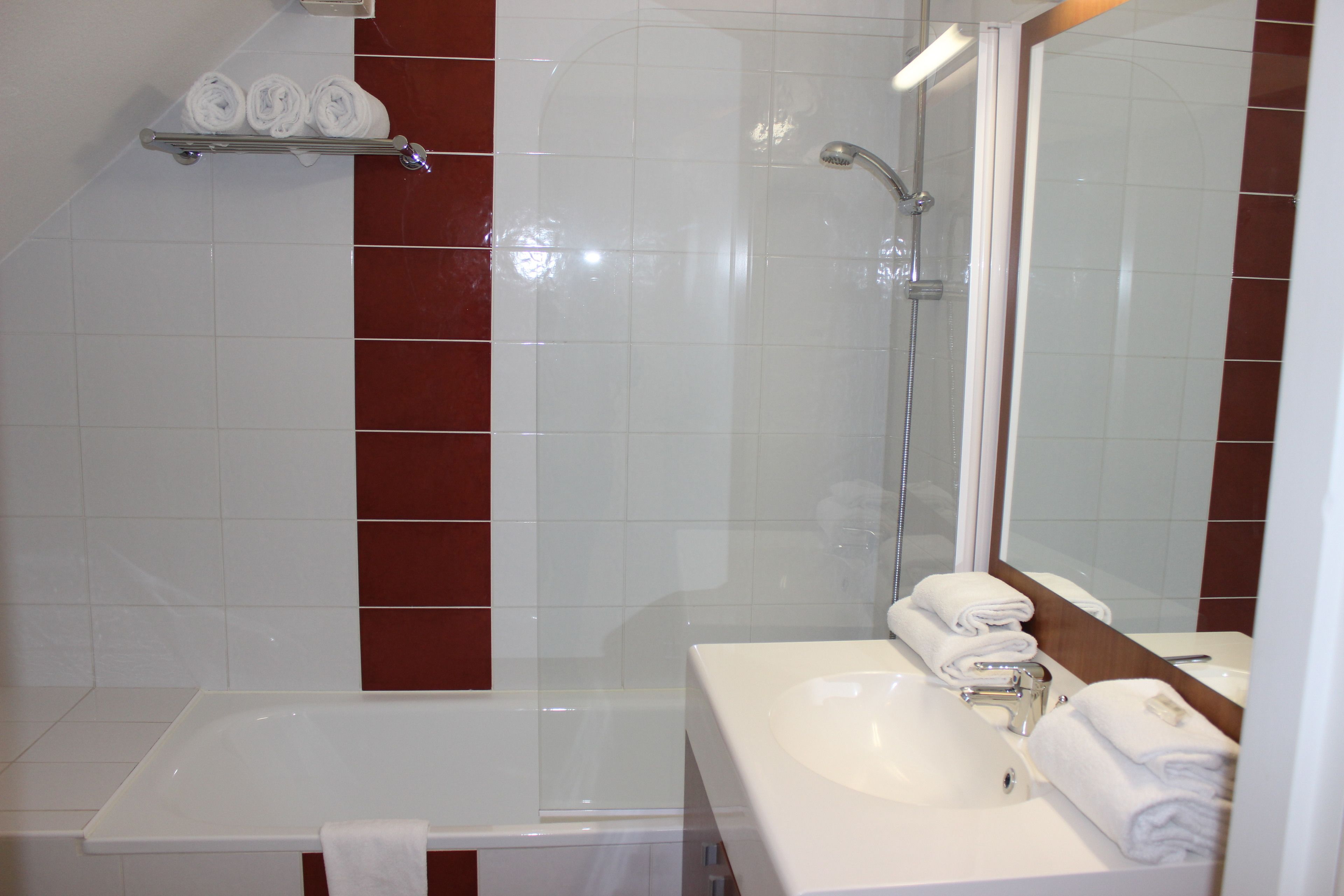 A bathroom with a bathtub, a sink, and a shower.