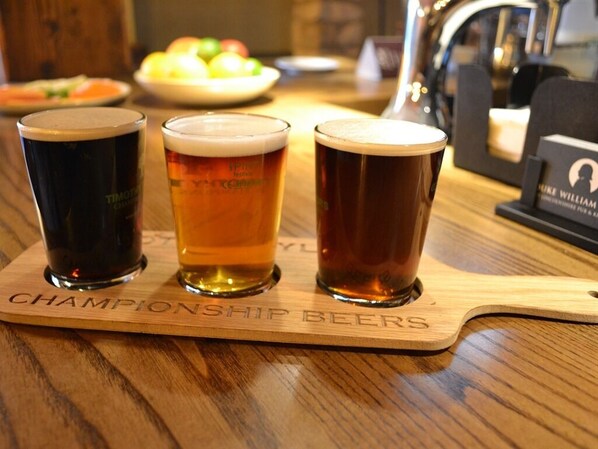 Three glasses of beer on a wooden coaster with the text "CHAMPIONSHIP BEERS".