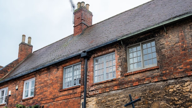 A traditional brick building with multiple windows and doors, a stone facade, and a tiled courtyard. - Duke William Hotel (Lincoln)