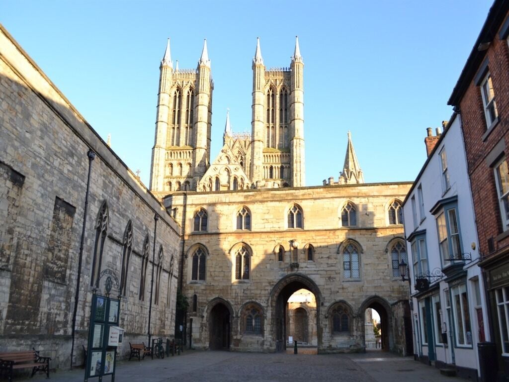 A historic building with a large arched entrance and tall towers.