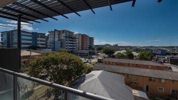 A residential area with modern apartment buildings, a McDonald's, and a Coles supermarket.